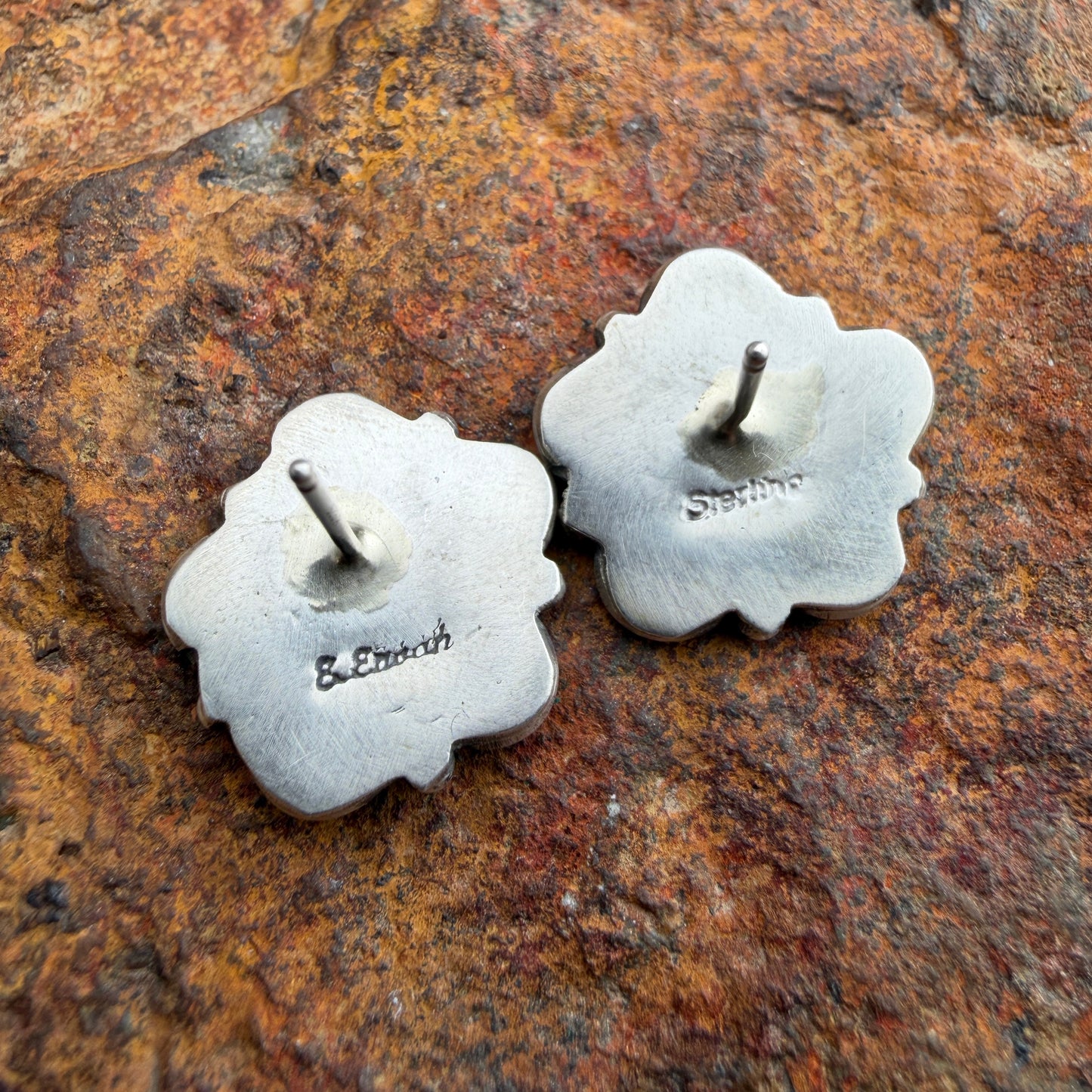  back of a pair of silver floral stamped Sterling and E.Enoah