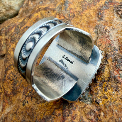 Back of a silver ring with stamping on is "Sterling" And "E. Enoah"