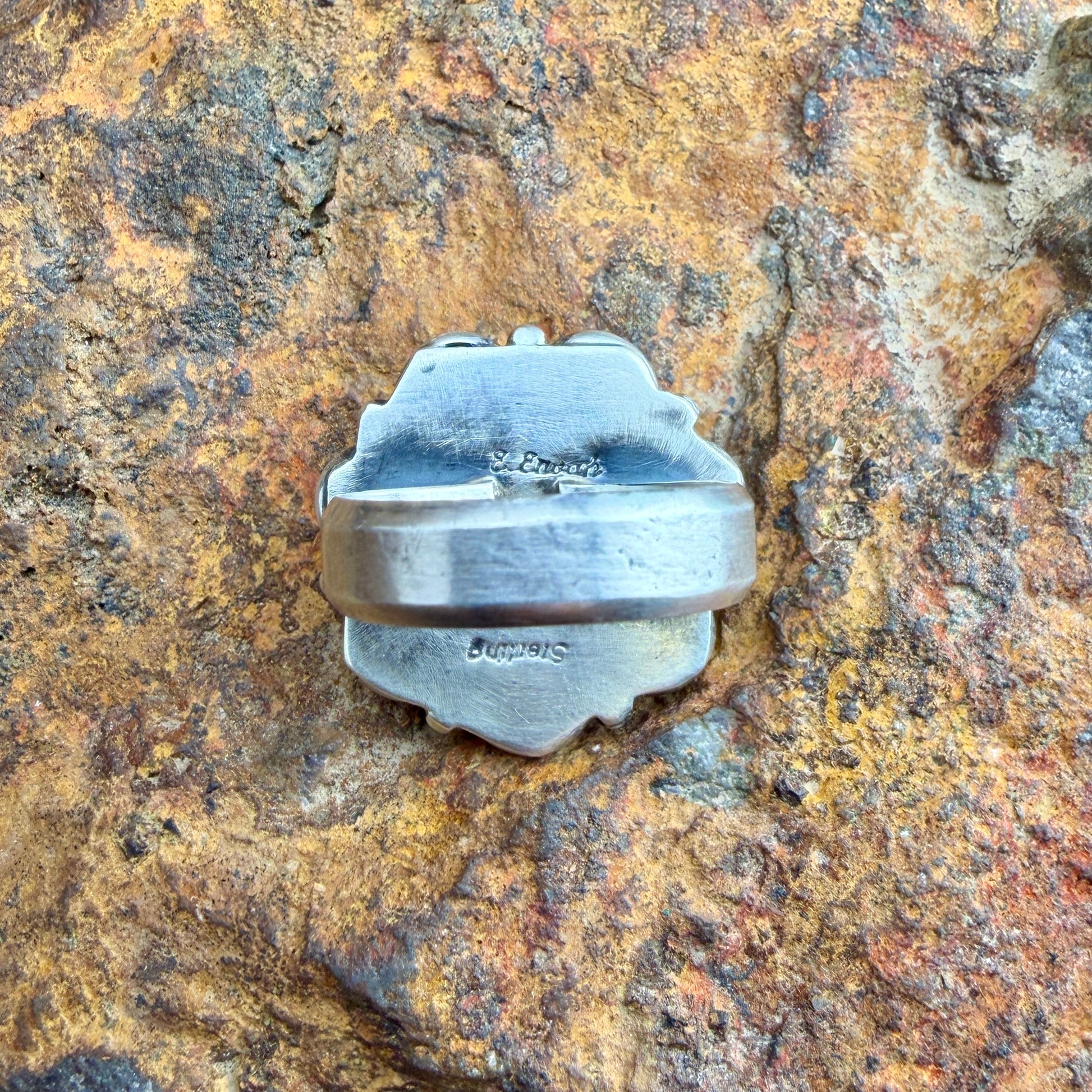Back of a ring with hand stamping "Sterling" and "E.Enoah"