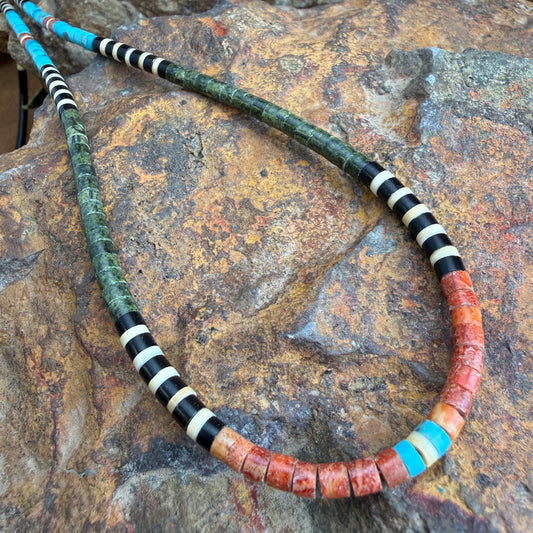 Necklace with multicolored beads on a stone surface