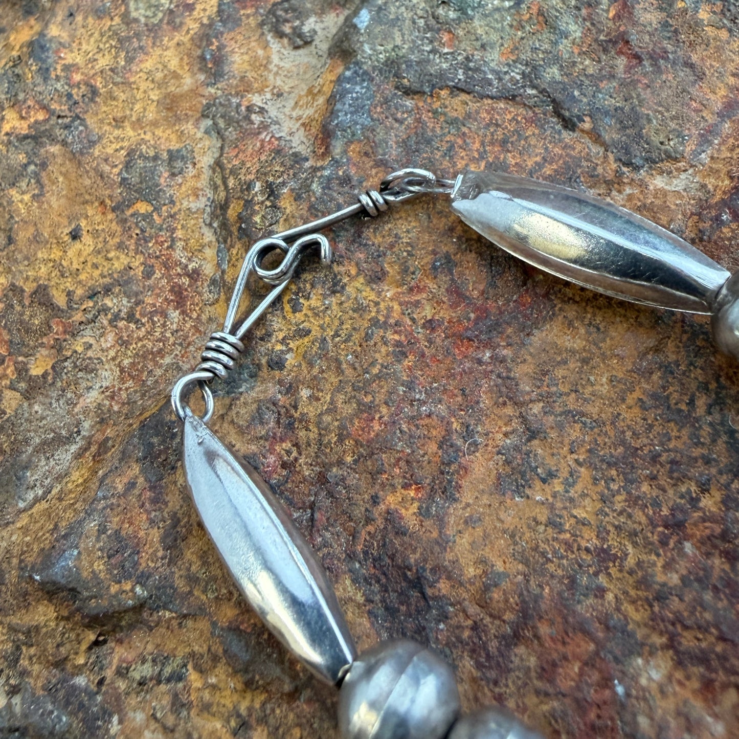 Close-up of a S clasp hook on the end of a necklace