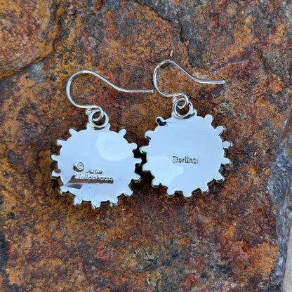 Backs of silver dangle earrings showing Artie Yellowhorse hallmark and Sterling stamp