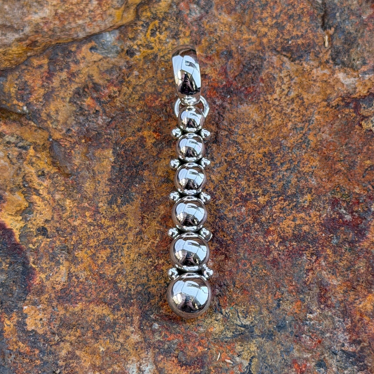 six sphere silver pendant showing Artie Yellowhorse