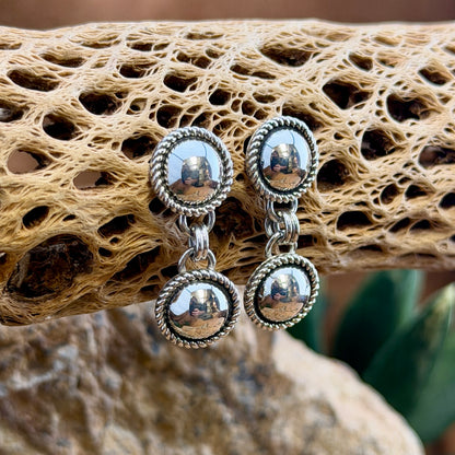 Front view of round silver dome earrings with linked drops and twisted-rope borders