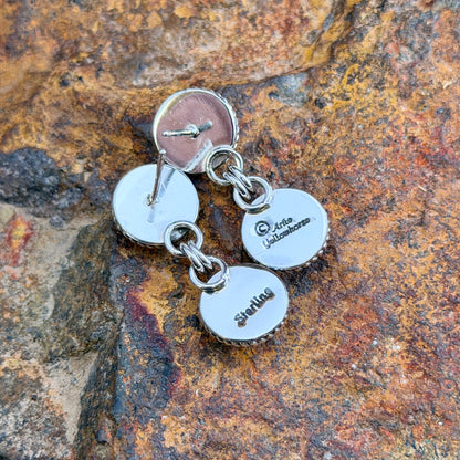Backs of Artie Yellowhorse post earrings showing artist hallmark and Sterling stamp