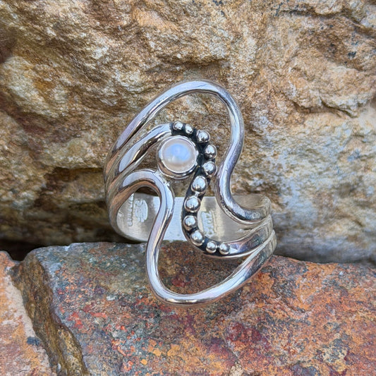 Side view of Ray Coriz freshwater pearl wave ring showing polished silver curves and darkened accent recesses