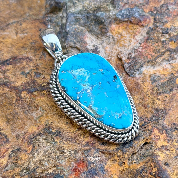 Kingman Turquoise Narrow Teardrop Pendant by Artie Yellowhorse, angled view