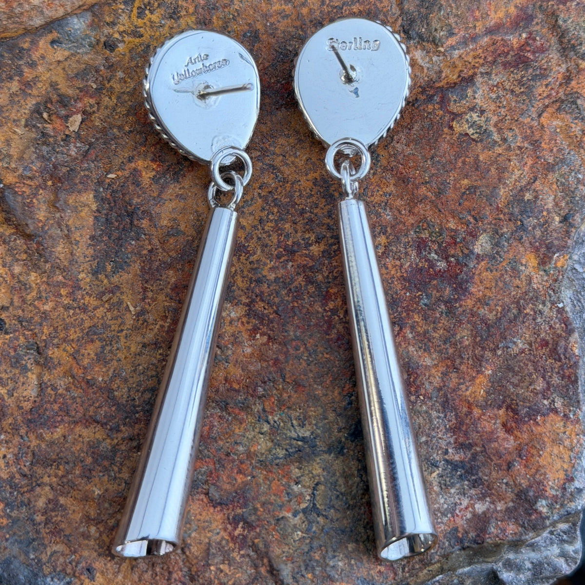 Backs of Artie Yellowhorse post-drop earrings showing hallmarks