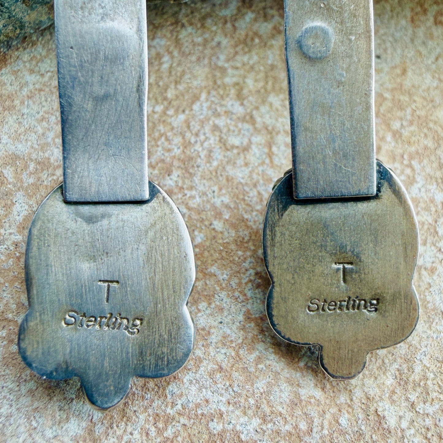 Back of silver earrings with "T" "STERLING" stamping