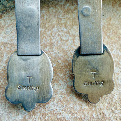 Back of silver earrings with "T" "STERLING" stamping