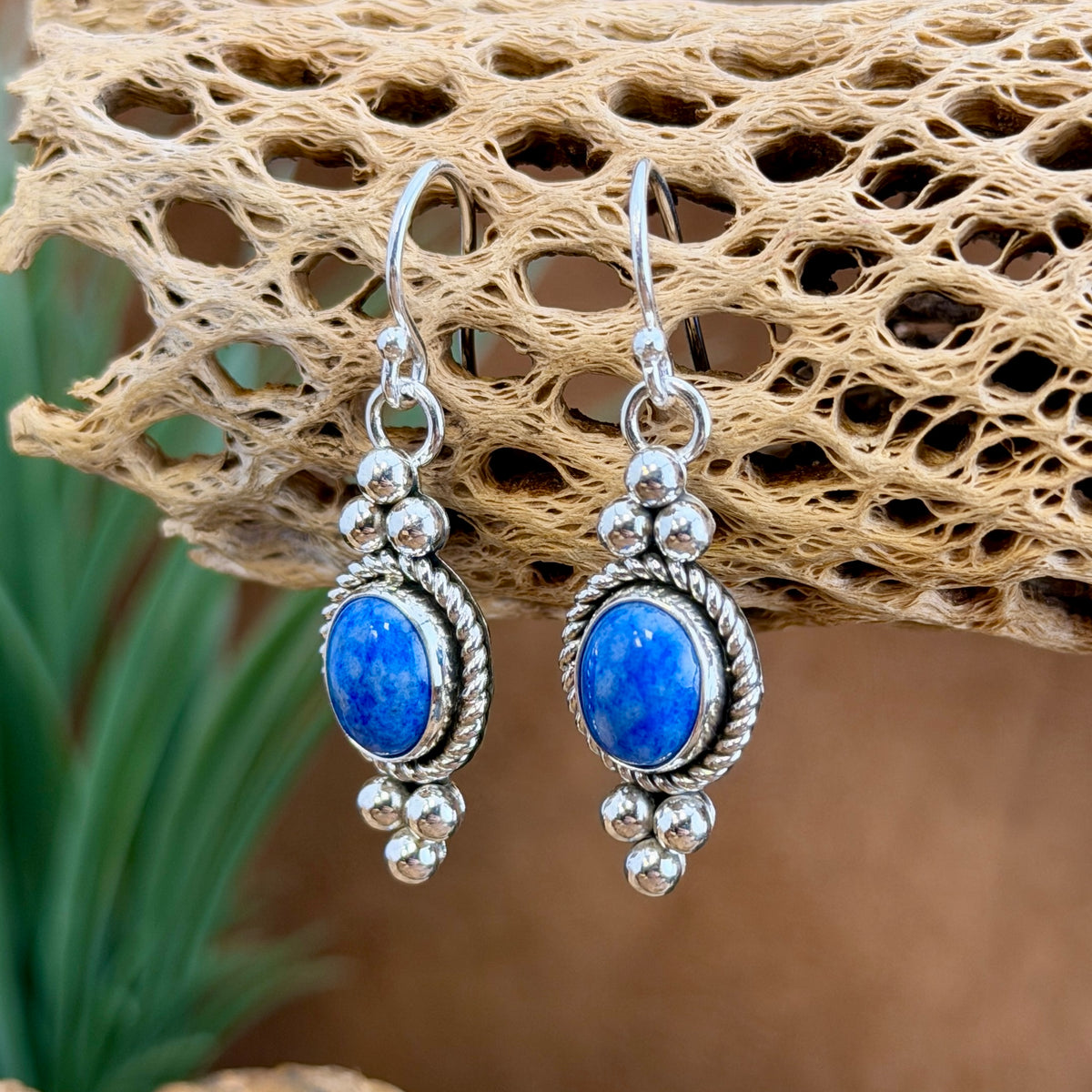Pair of denim-blue lapis dangle earrings with twisted-rope sterling silver borders and bead accents