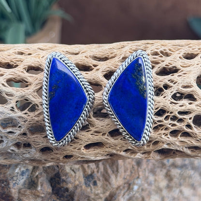 Reverse of Artie Yellowhorse sterling silver post earrings, showing the artist hallmark