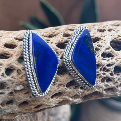 Front view of shield-shaped lapis lazuli earrings with pyrite flecks by Artie Yellowhorse