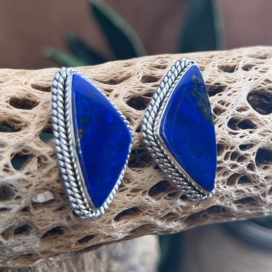 Front view of shield-shaped lapis lazuli earrings with pyrite flecks by Artie Yellowhorse