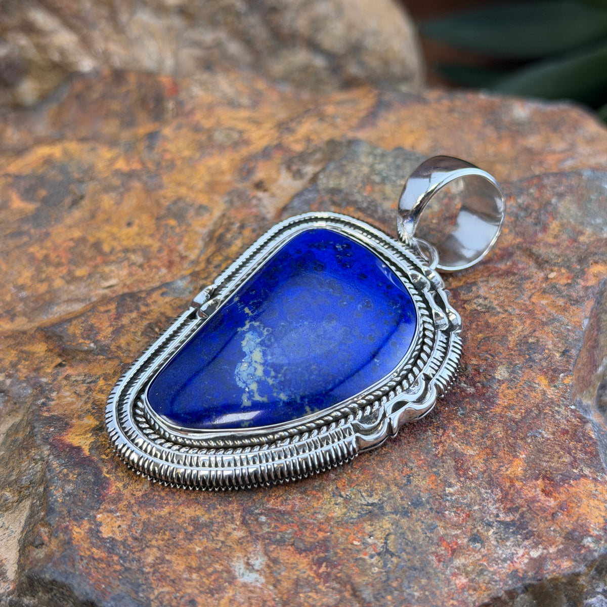 Royal Lapis Sterling Silver Pendant by Henry Chackee and Artie Yellowhorse, angled front view