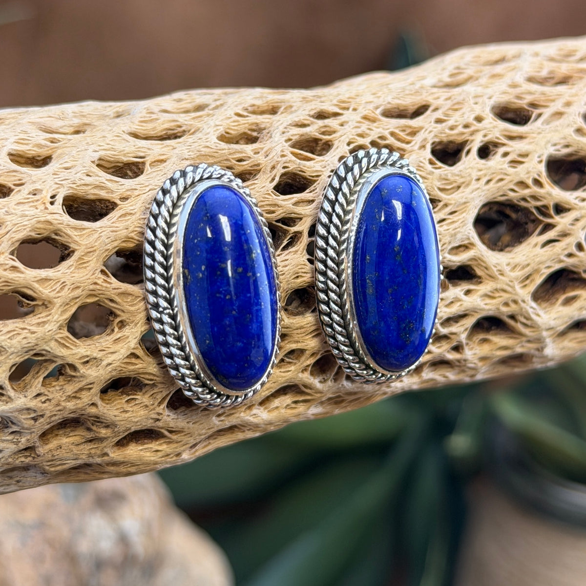 Front view of oval lapis lazuli cabochon post earrings by Artie Yellowhorse