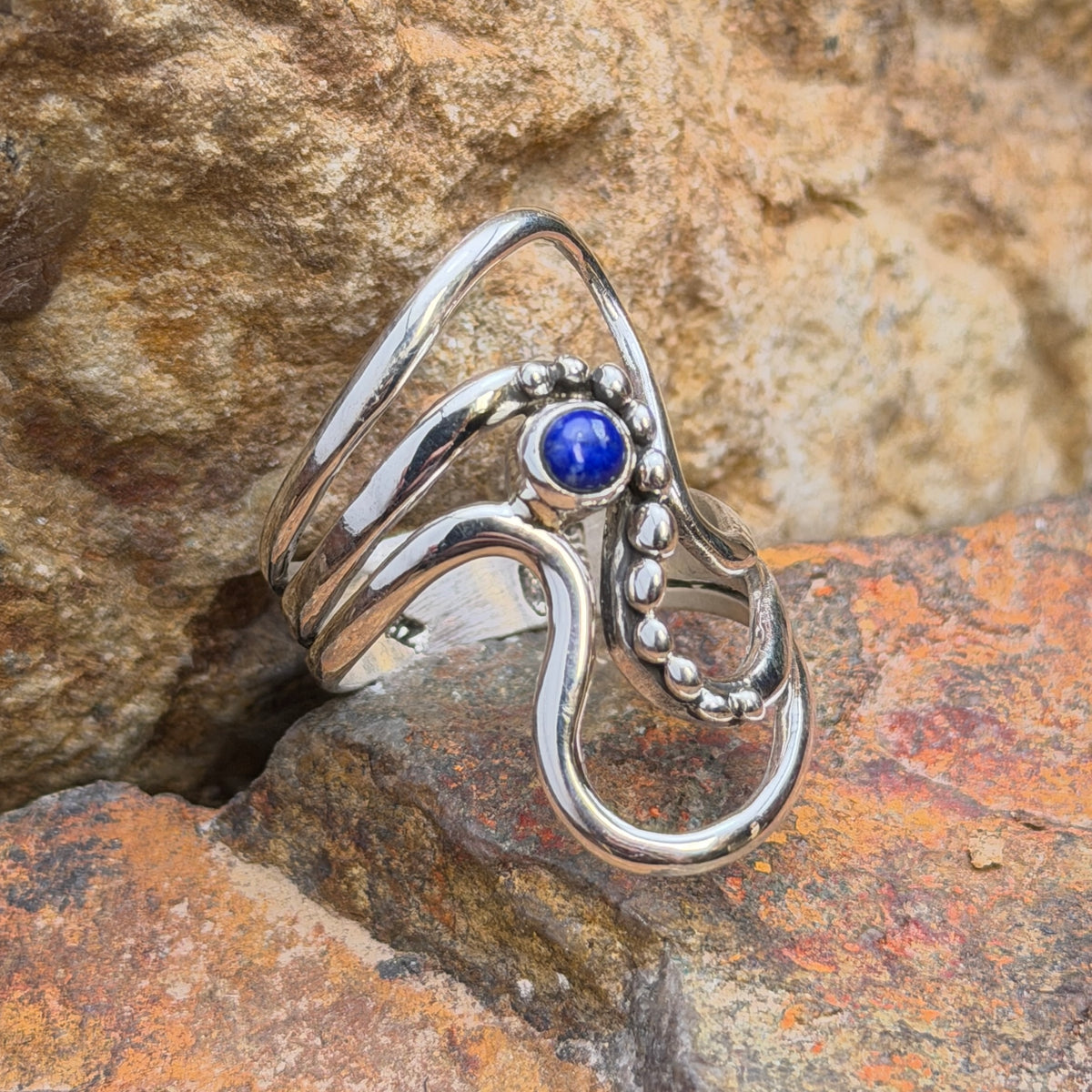 Lapis wave ring by Ray Coriz with rounded silver accents, angled view