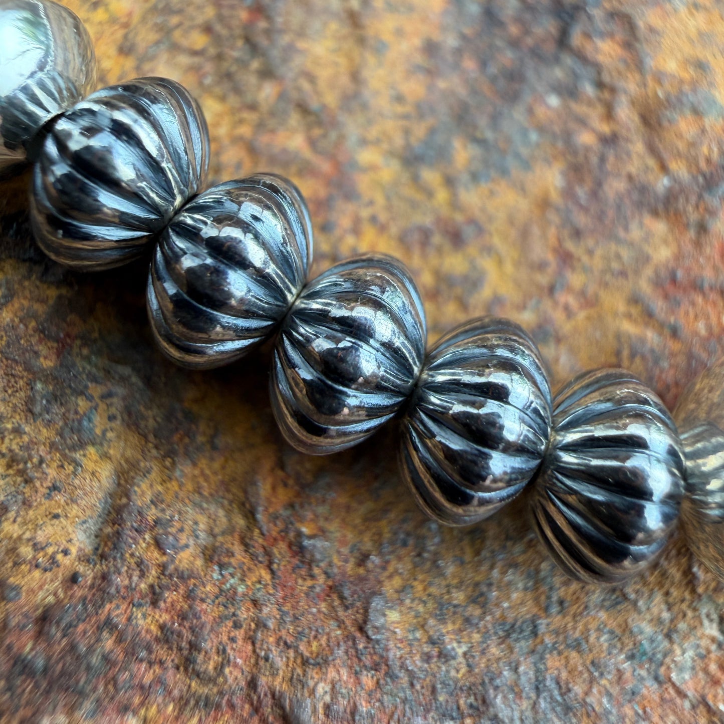 close up shot of beads on necklace, features a melon ridge design on oxidized beads