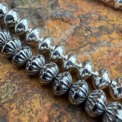 Silver beaded bracelet on a textured brown surface