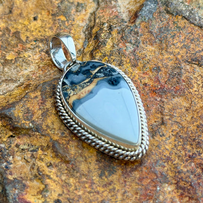 Maligeno Jasper Pendant by Artie Yellowhorse - front view showing shield-shaped stone with landscape banding and twisted rope border