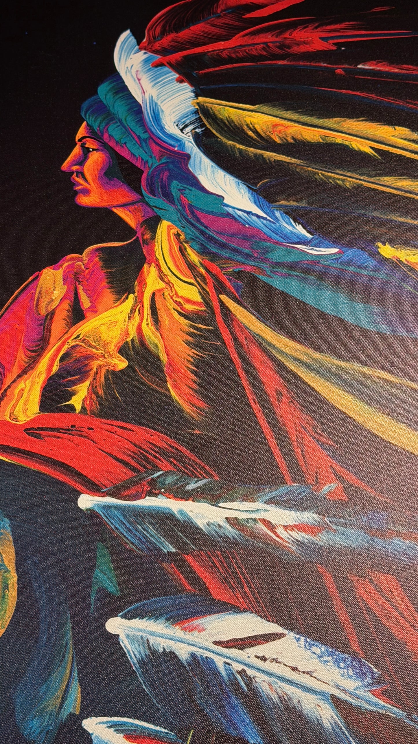 Vibrant, colorful art print depicting a Native American profile wearing a feathered headdress, rendered in bold strokes of red, yellow, blue, and white against a dark background.