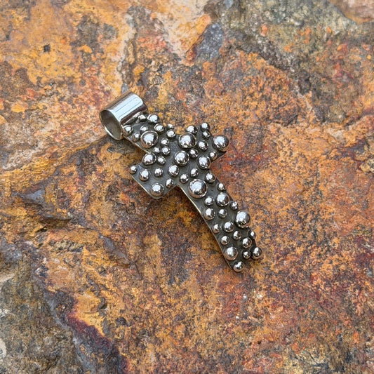 Polished silver drops and broad bail on Akee Douglas cross pendant