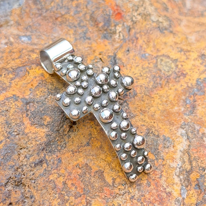 Million Drops curved cross pendant by Akee Douglas, front view