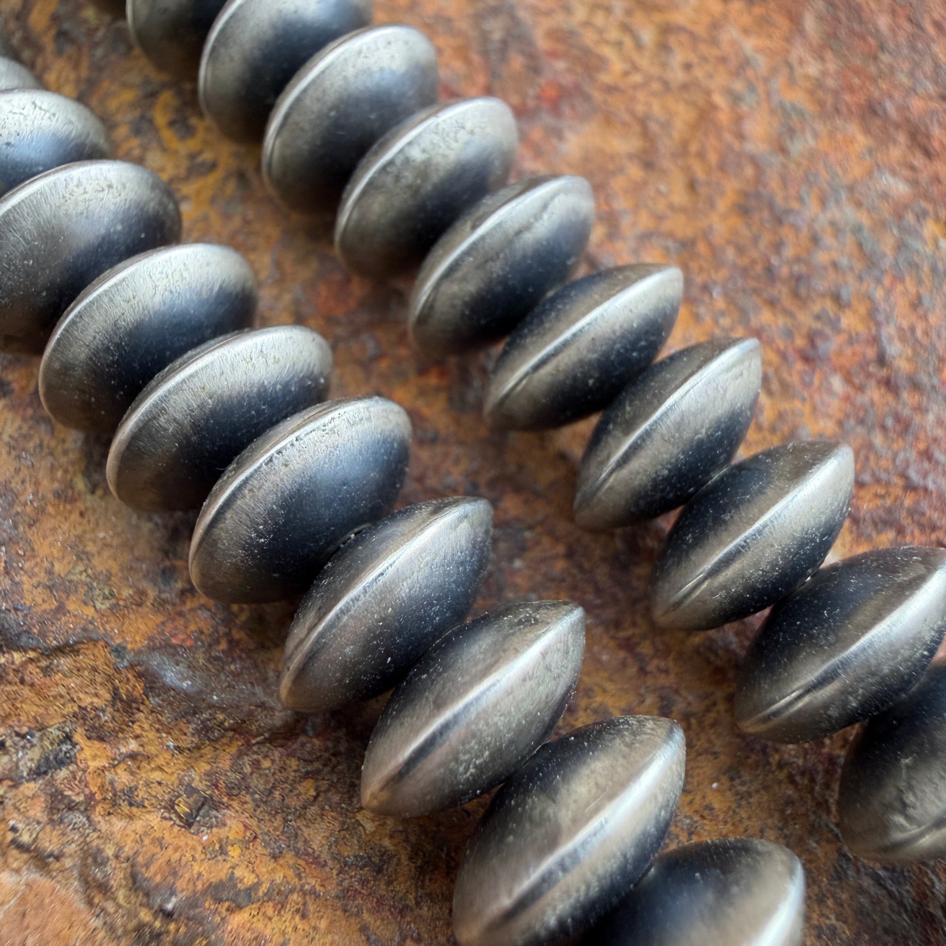 Close up of oxidized sterling silver saucer beads
