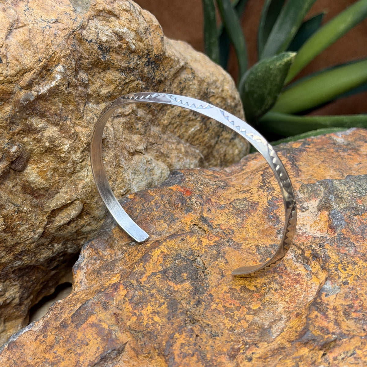 Open sterling silver leaf stamped cuff by Verna Tahe