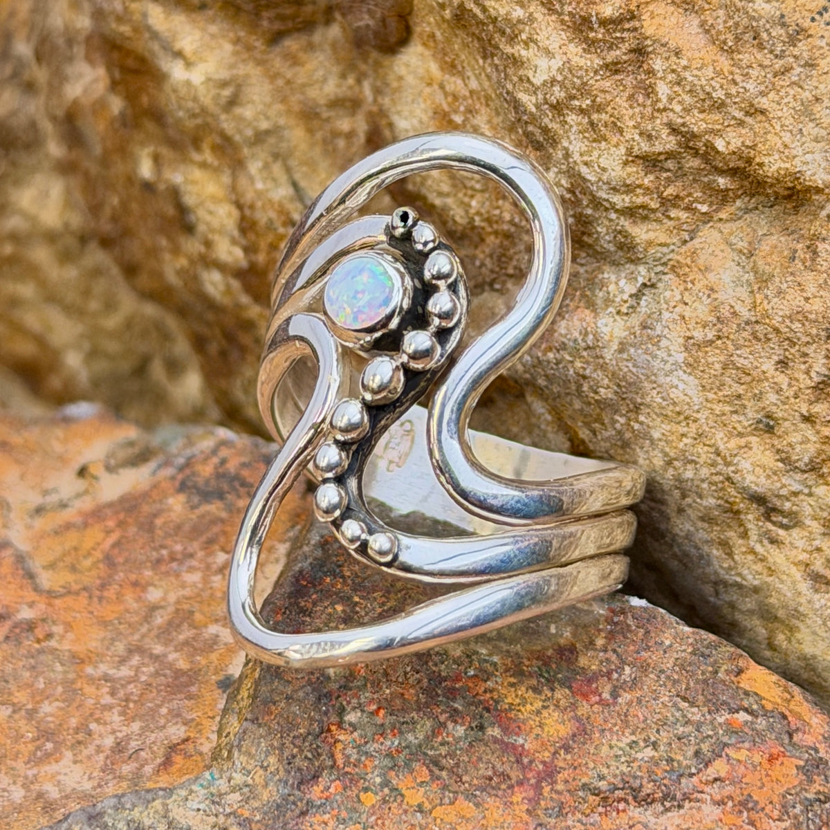 Side view of size 9 opal sterling silver wave ring by Ray Coriz
