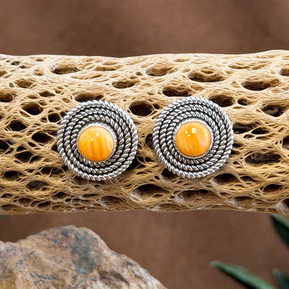 Orange Spiny Oyster round post earrings with twisted-rope borders, front view