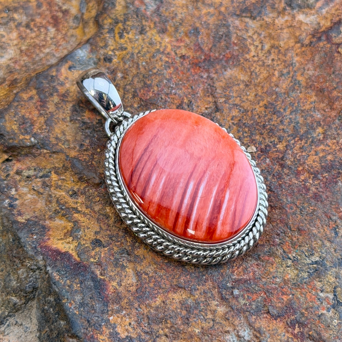 Red Spiny Oyster Sterling Pendant by Artie Yellowhorse, angled view