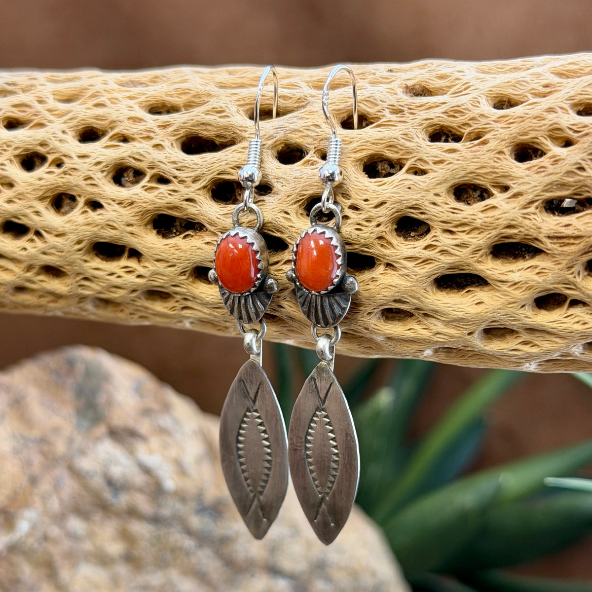 Backs of Mary Tso earrings showing T hallmark and Sterling stamps