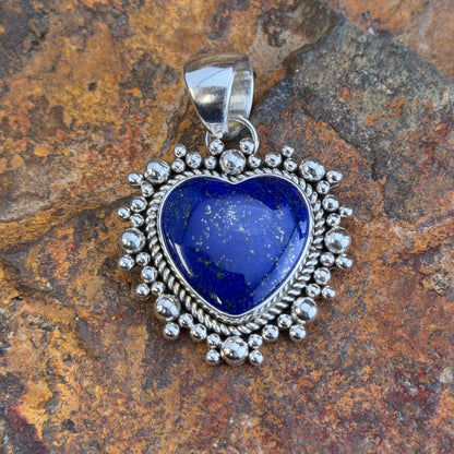Royal Lapis heart pendant surrounded by a rope border and silver beads. 