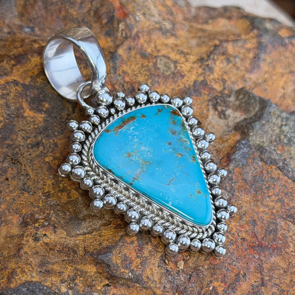 Front of large Royston turquoise sterling silver pendant with bead border