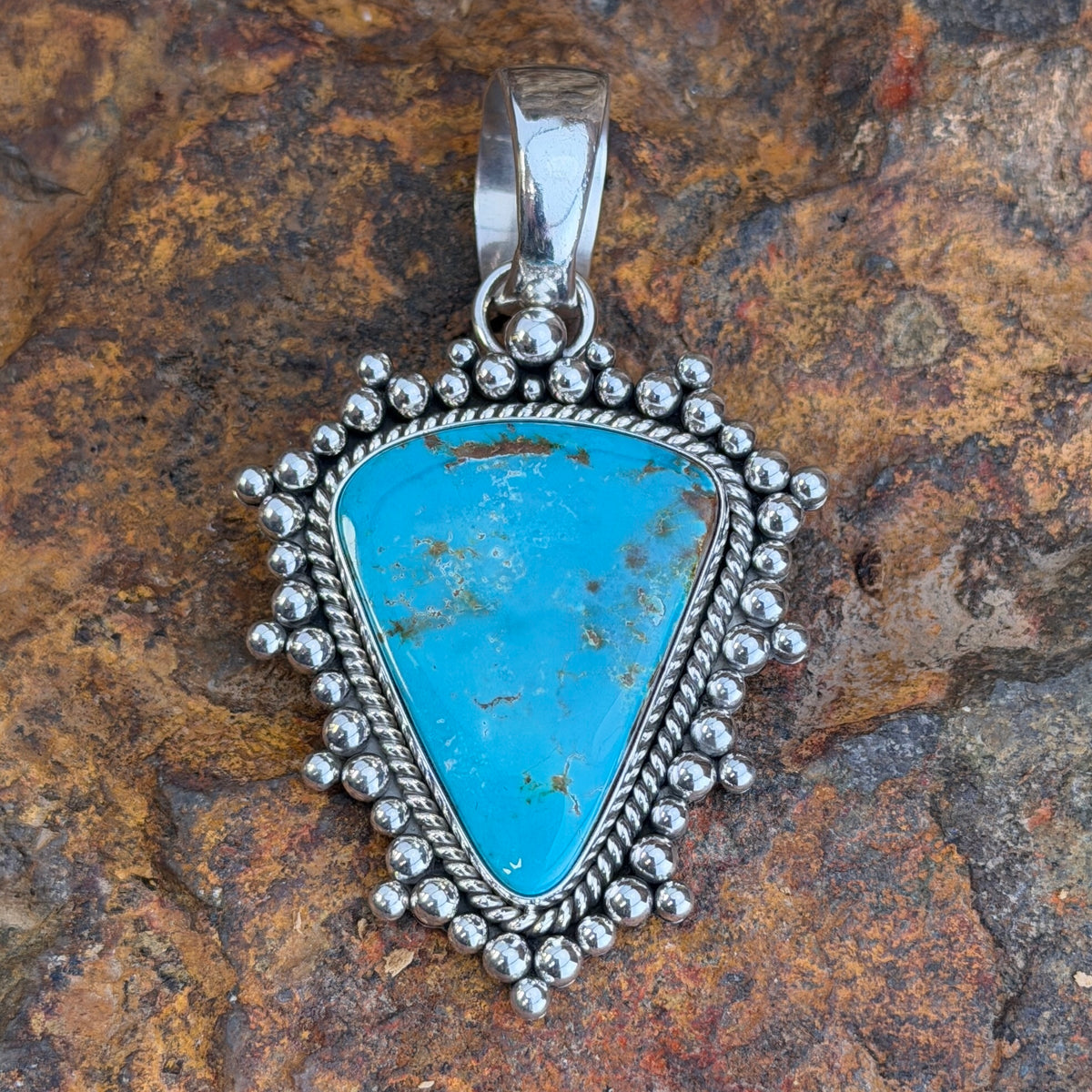 Back of Artie Yellowhorse pendant showing Sterling hallmark