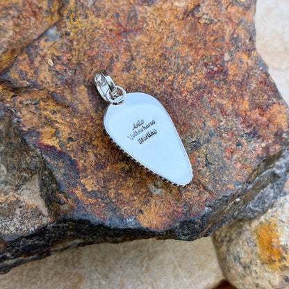 Angled view of Artie Yellowhorse Royston turquoise teardrop pendant