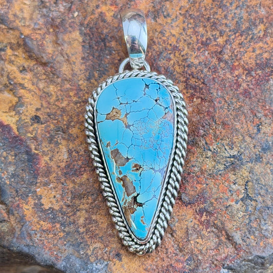 Front of blue Royston turquoise teardrop pendant with silver rope border