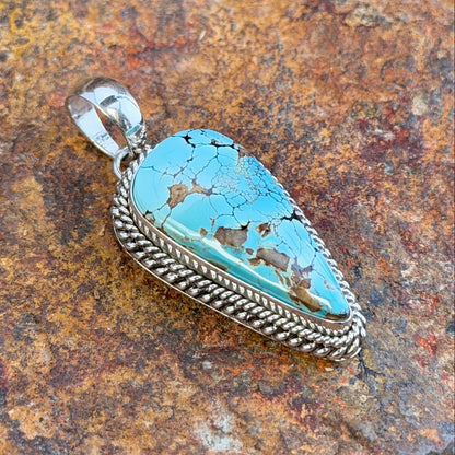 Oblique view of Royston turquoise pendant and polished bail