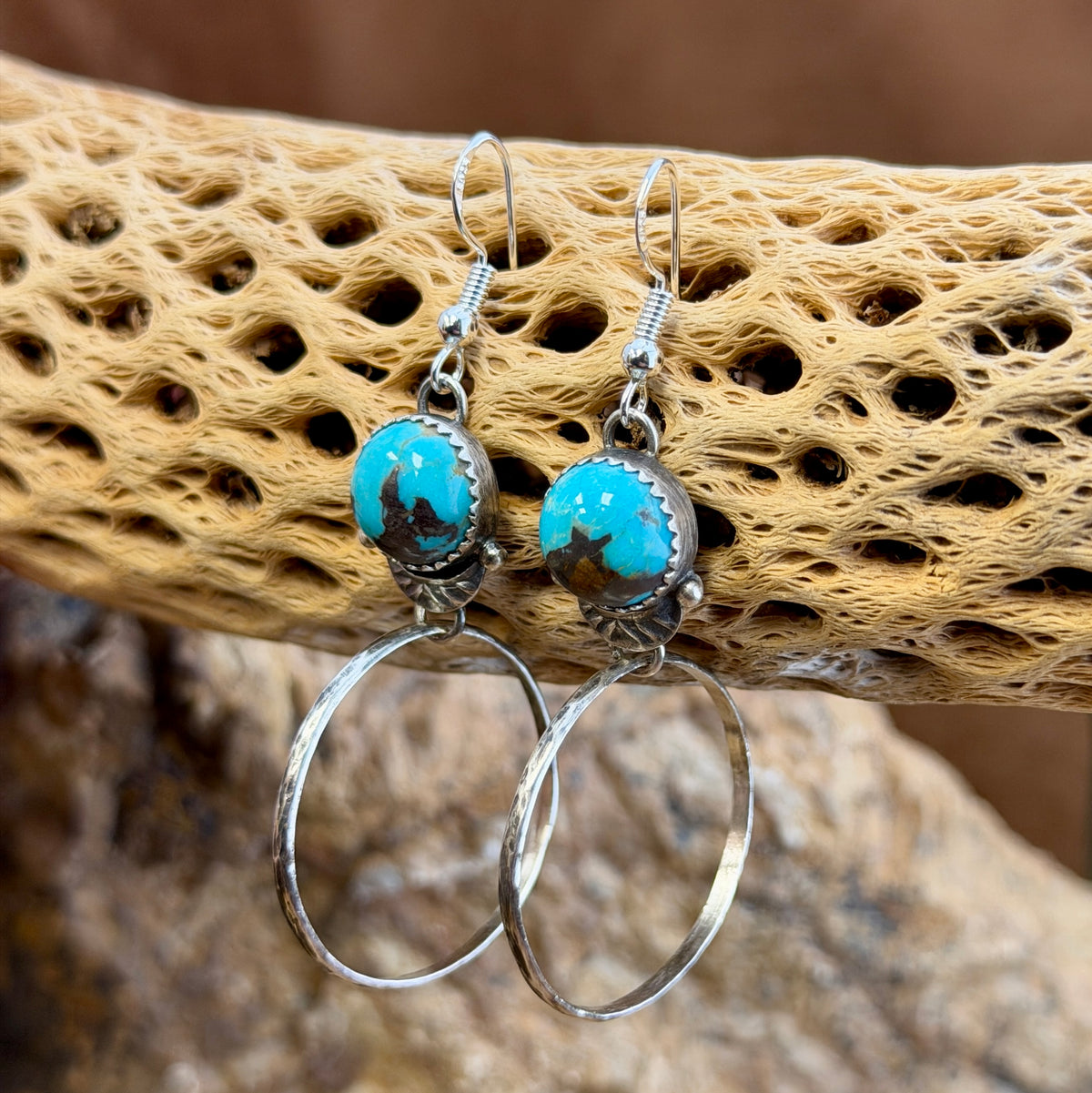 round blue toned royston turquoise cabochons with hoops that dangle from them. made by mary tso