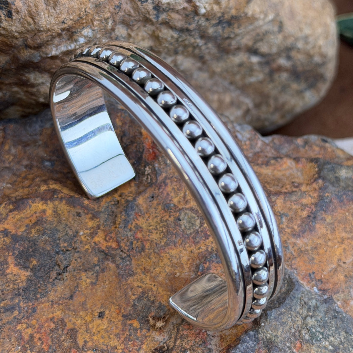 Artie Yellowhorse sterling silver cuff with centered bead row and polished borders