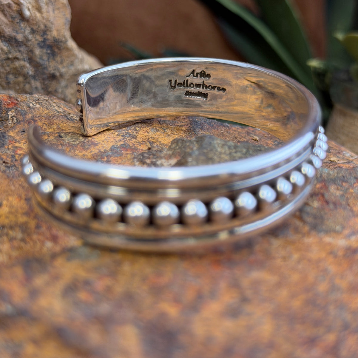Interior of sterling silver cuff showing Artie Yellowhorse and Sterling hallmarks