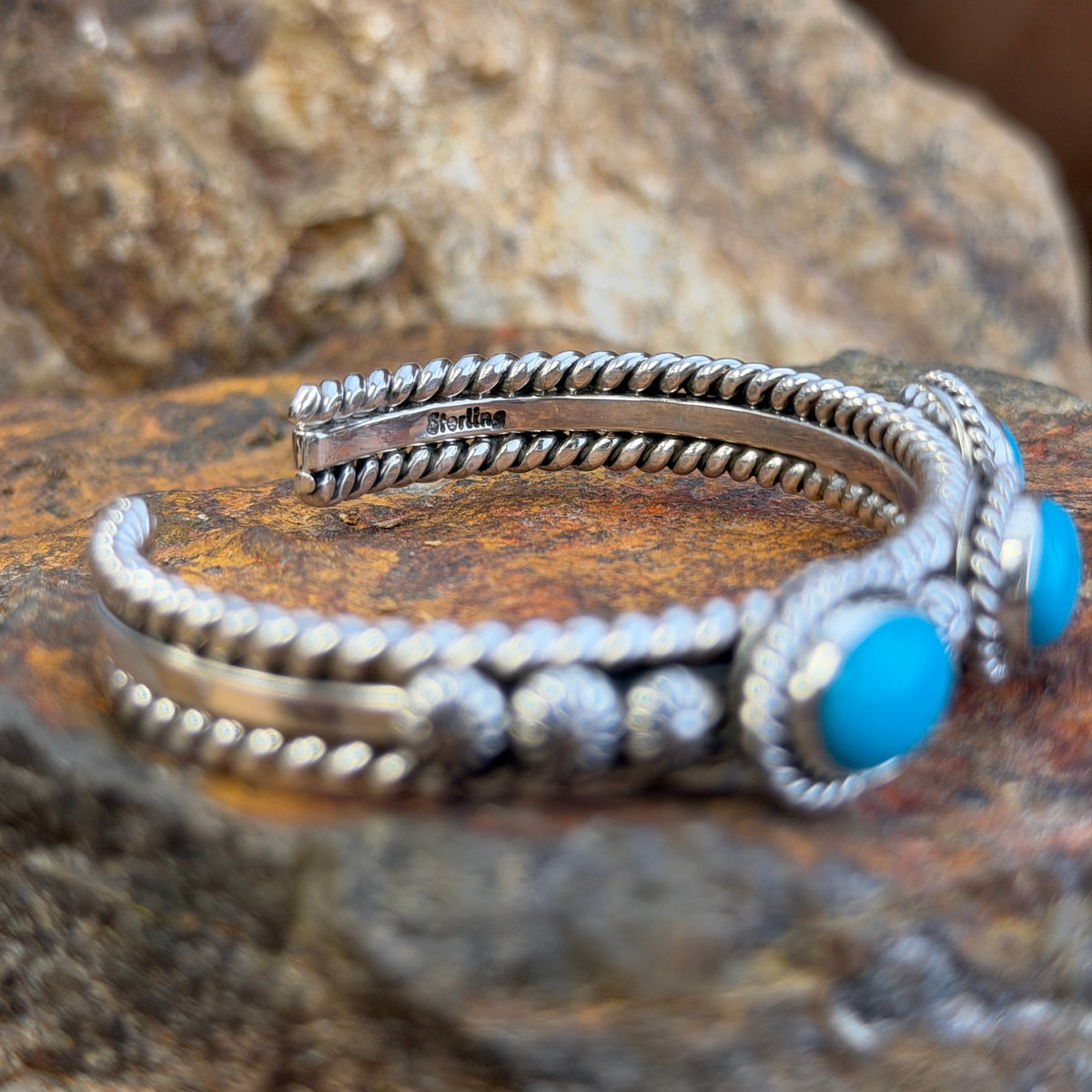 Top view of three Sleeping Beauty turquoise stones on sterling silver cuff