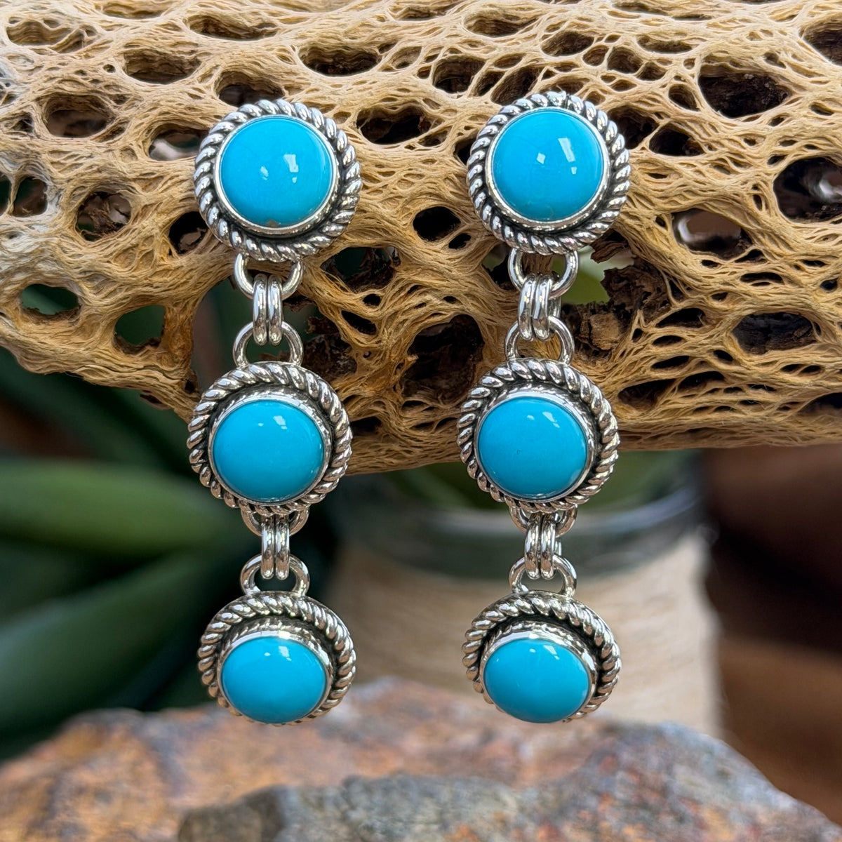 Angled view of Sleeping Beauty turquoise three-drop sterling silver earrings