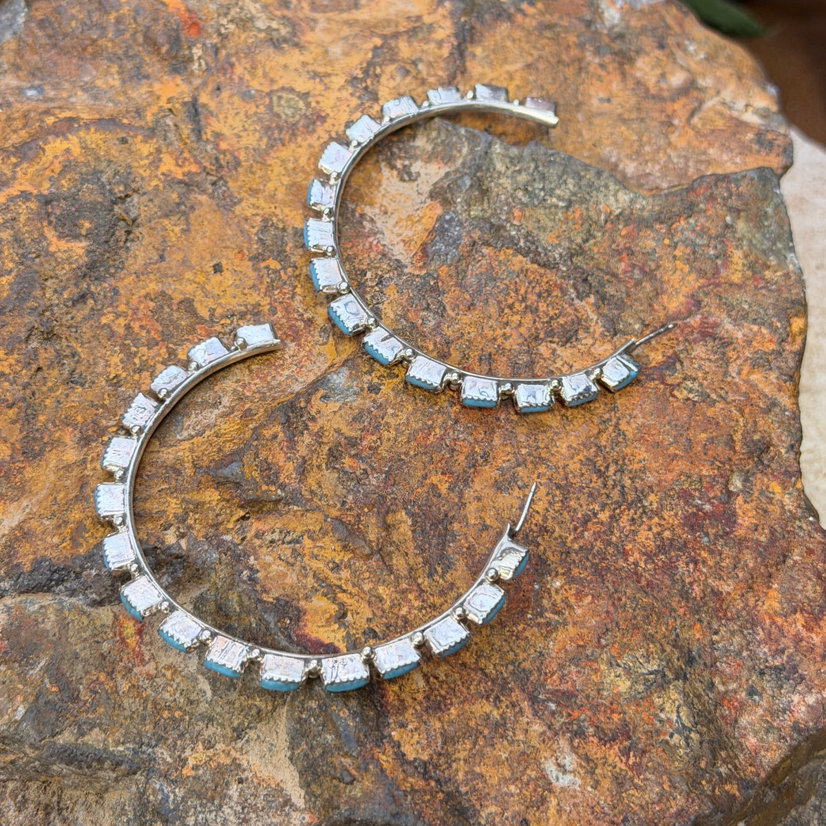 A. Hughte turquoise hoop earrings showing post attachments