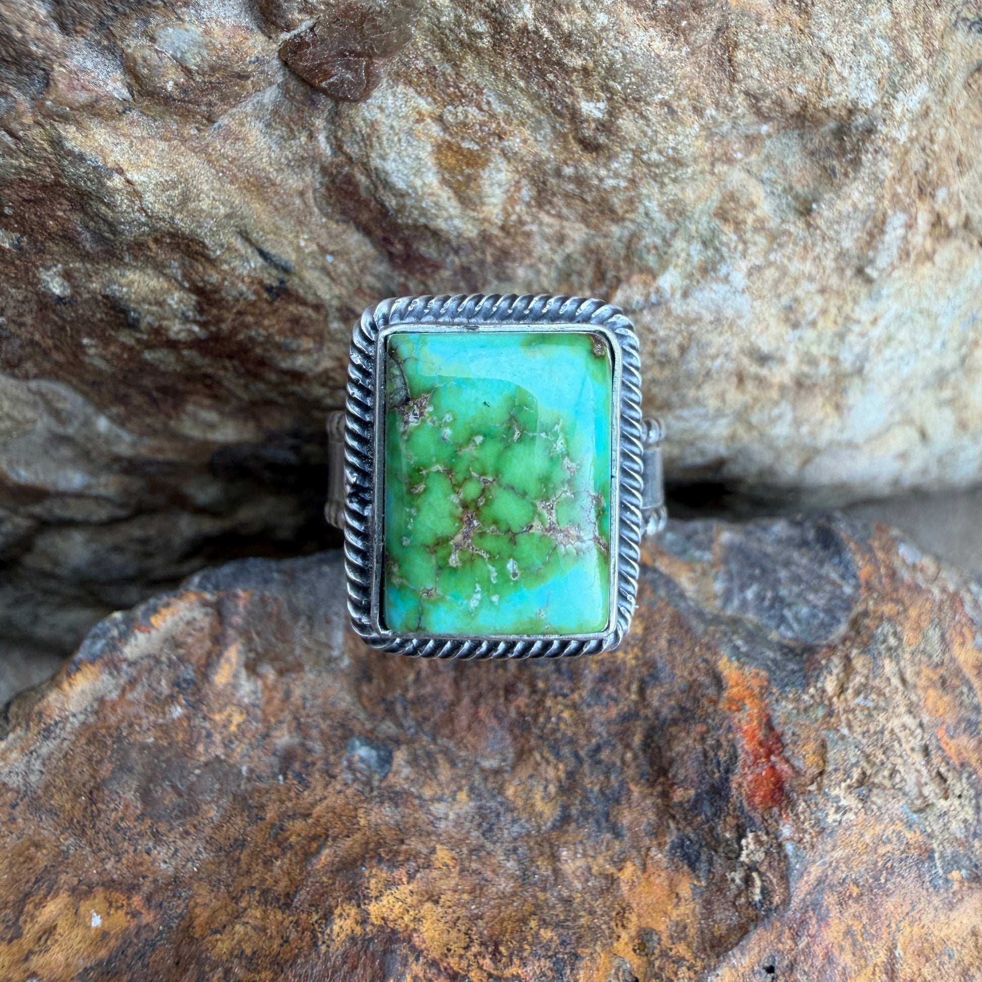 Turquoise stone ring on a textured rock background