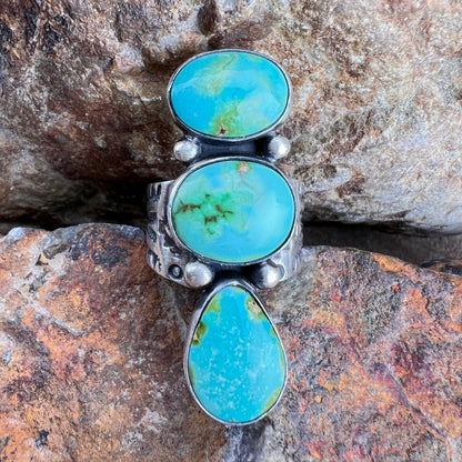 Turquoise stone ring on a rocky surface