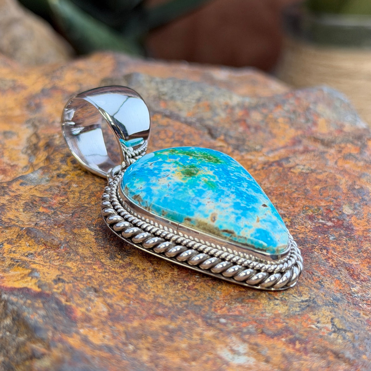 Side angle of Sonoran Gold turquoise pendant and polished bale
