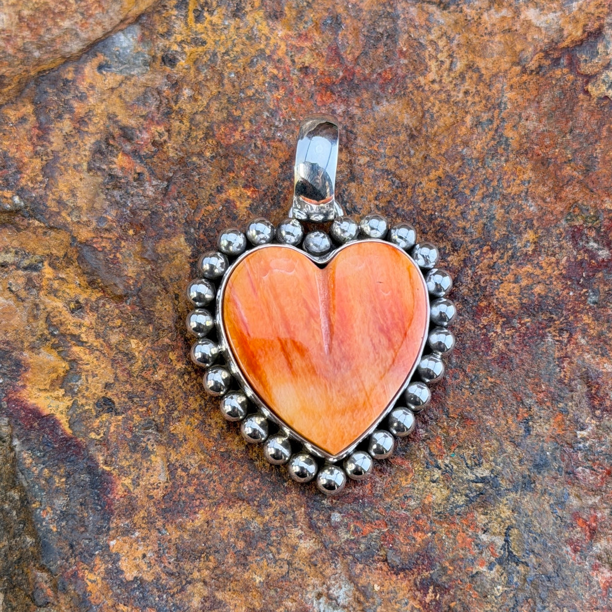 Small Spiny Oyster Heart Sterling Pendant by Artie Yellowhorse, angled view