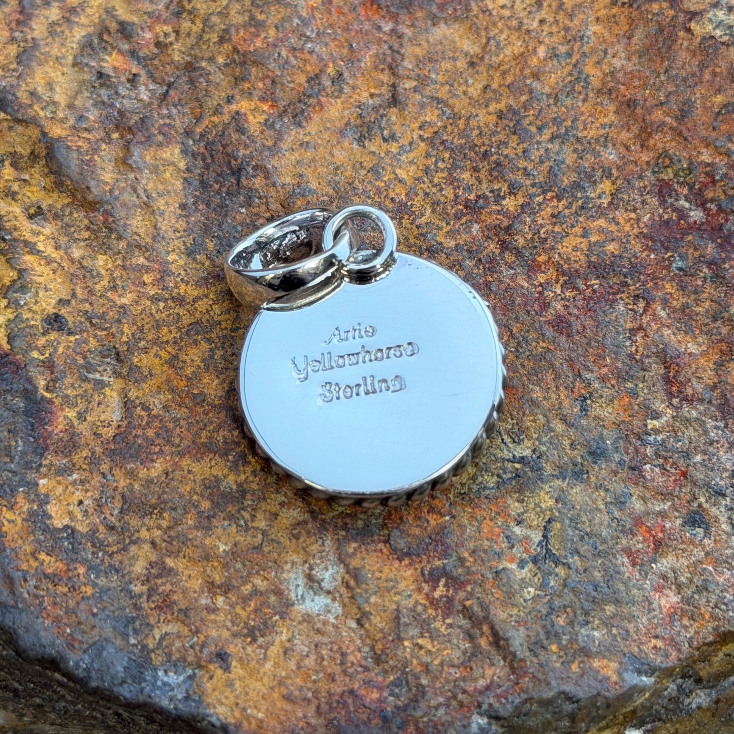  A pendant with a looped bail. The back is stamped "Artie YelowHorse" Sterling"